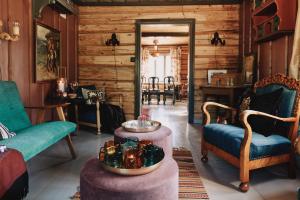 a living room with wooden walls and a table and chairs at Reinheimen Lodge in Skjåk