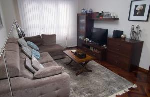 a living room with a couch and a tv at GaliciaGuestHome Avenida Vigo 62 in Pontevedra +13 photos