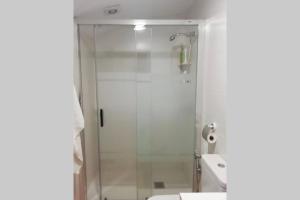 a shower with a glass door in a bathroom at Cueva de Ramón y Elvira in Cuevas del Campo