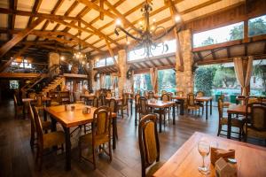 a restaurant with wooden tables and chairs and windows at Hotel Casablanca Spa & Wine in Casablanca