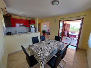 a dining room and kitchen with a table and chairs at Apartments Gracia & Toni in Trogir