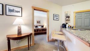a hotel room with a vanity and a desk with a lamp at Sunstone #322 condo in Mammoth Lakes