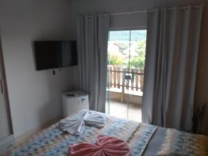 Postelja oz. postelje v sobi nastanitve Pousada Canto Dos Passaros