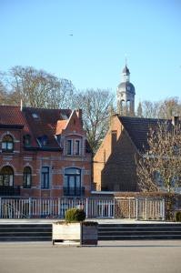 a large brick building with a clock tower in the background at B&B Kaai 16 in Halle