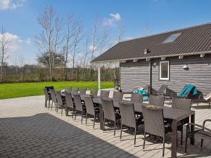 a patio with a table and chairs and a house at Holiday home Kappeln XXIV in Kappeln