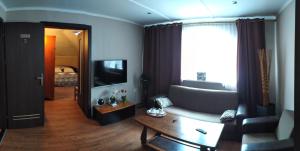 a living room with a couch and a table at Villa Lido in Gdańsk