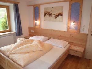 a bedroom with a bed with two pillows on it at Residence Ferienheim Folie in Melago