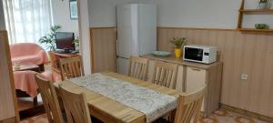 a small kitchen with a table and a microwave at Apartmani Sladana in Kampor
