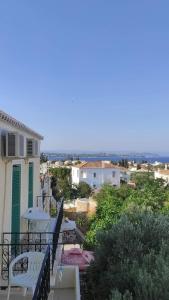 a balcony of a house with a view of the ocean at Bay's in Spetses