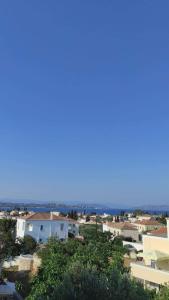 a view of a city with houses and the ocean at Bay's in Spetses