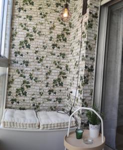 a brick wall with a bench in front of a window at CARMELA in Santiago de Compostela