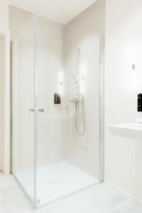 a shower with a glass door in a bathroom at The Librarian by Domani Hotels in Ghent +26 photos