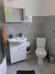 a bathroom with a white toilet and a sink at Dom pod lasem in Ruciane-Nida +11 photos