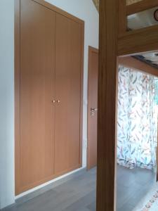 a bedroom with wooden cabinets and a window at Hostel Sertã in Sertã