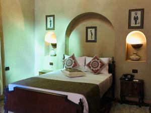 a bedroom with a large bed with pillows on it at Djorff Palace in Luxor