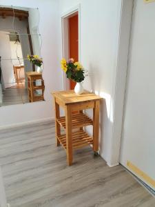 einen Tisch mit einer Blumenvase drauf in der Unterkunft Helle, moderne Altbauwohnung in Zentrumsnähe in Osnabrück