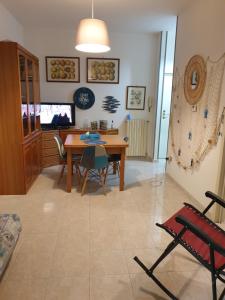 a dining room with a table and chairs and a television at CASA GINEVRA in Silvi Marina