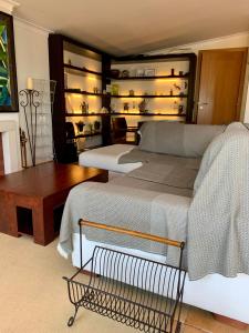a bedroom with two beds and a table and shelves at Seazimbra - Luxury Apartment in Sesimbra