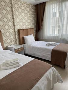 Postel nebo postele na pokoji v ubytování Bursa Malkoc Hotel
