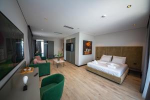 a bedroom with a bed and a living room at Apart-Hotel Lili2 in Sarandë