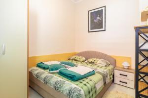 a bed with two pillows on it in a room at Apartment Belman in Igalo