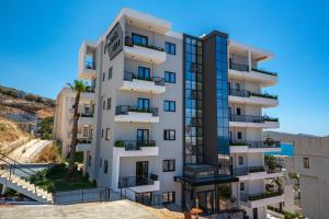 a tall white building with balconies on it at Apart-Hotel Lili2 in Sarandë