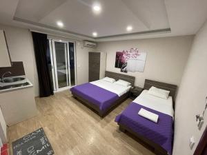 a hotel room with two beds and a kitchen at Apartments Lati in Ulcinj