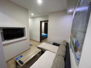 a small room with a couch and a tv at Apartments Lati in Ulcinj
