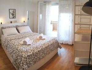 a bedroom with a bed with two towels on it at Apartment Leone Umag in Umag