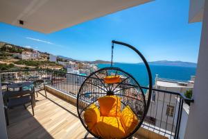 a room with a balcony with a swing at Apart-Hotel Lili2 in Sarandë