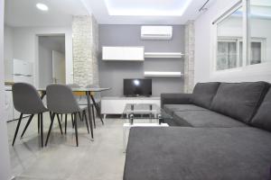 a living room with a couch and a table at Luxury Suites Fuengirola 2 in Fuengirola