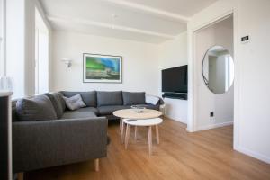 a living room with a couch and a table at Luxurious House in Downtown Tórshavn in Tórshavn