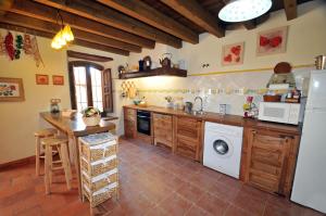 a kitchen with a refrigerator and a dishwasher at La Fuente de Pavia in Caballar