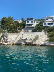 a view of the water with houses in the background at Apartment First Row in Komarna