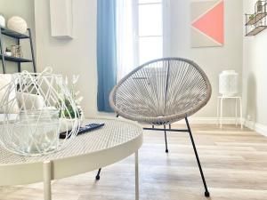 a chair and a table in a living room at Arina & Julien Dieppe in Dieppe