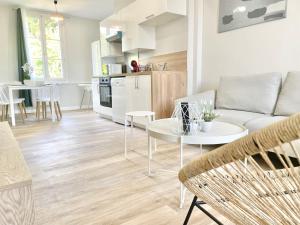 a living room with a couch and a table at Arina & Julien Dieppe in Dieppe
