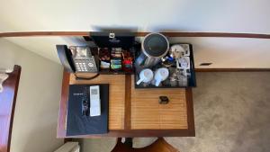 a desk with a phone and other items on it at Grand Arden Monaco Nelson in Nelson +24 photos