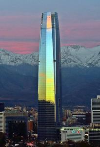 un edificio alto con un arco iris en una ciudad en Apartament Condo Amueblado, ENCOMENDEROS 200 El Golf, Las Condes Santiago con vista al Costanera Center en Santiago