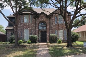 a brick house with trees in front of it at Remodeled luxury with Proximity in Lewisville