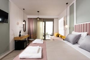 a bedroom with a large bed and a living room at Alkyon Hotel in Limenas