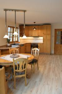 a large kitchen with a wooden table and chairs at Haus Alpenrose zum Vic in Wermelskirchen +22 photos