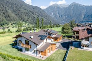 an aerial view of a house with mountains in the background at Fulun Mountain Lodge in Giustino