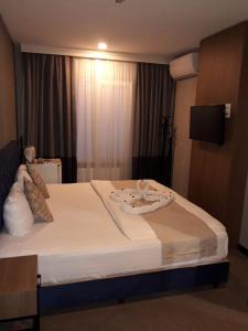 Postel nebo postele na pokoji v ubytování Nostalji Hotel