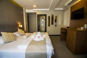 Postel nebo postele na pokoji v ubytování Nostalji Hotel