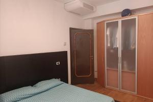 a bedroom with a bed and a sliding glass door at Appartamento centro cagliari in Cagliari