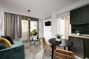 a kitchen and living room with a table and a couch at Alkyon Hotel in Limenas