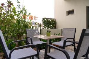 a table and chairs sitting on a patio at Avra in Agia Galini