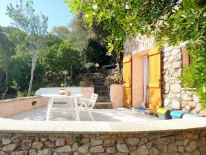 a white table and chairs on a stone patio at Appartamento Vasiliki in Porto San Paolo