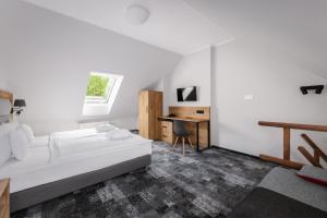 a white bedroom with a bed and a desk at Hotel Vivaldi in Karpacz +37 photos