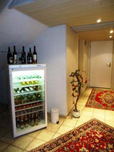 a refrigerator filled with lots of bottles of wine at Hotel Kurallee in Meersburg